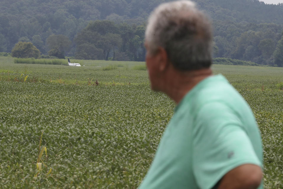 Daniel Alsup, looks at an airplane that crash-landed in a field near his Ripley, Miss. home on Saturday, Sept. 3, 2022. Authorities say a man who stole a plane and flew it over Mississippi after threatening to crash it into a Walmart store faces charges of grand larceny and terroristic threats. Tupelo Police Chief John Quaka said Cory Wayne Patterson didn't have a pilot's license but had some flight instruction and was an employee of Tupelo Aviation. (AP Photo/Nikki Boertman)