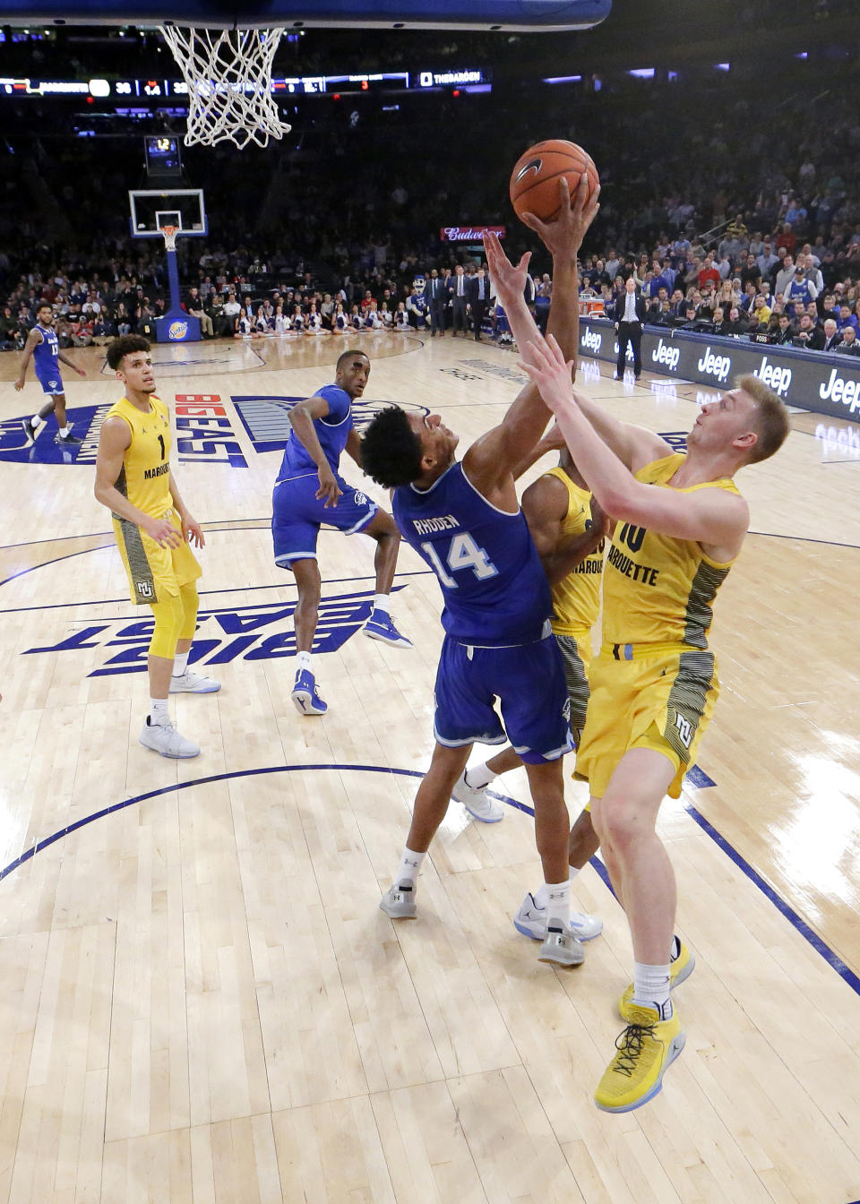 Seton Hall guard Jared Rhoden (14) competes for a rebound against Marquette forward Jamal Cain (23) and forward Sam Hauser (10) during the first half of an NCAA college basketball semifinal game in the Big East men's tournament, Friday, March 15, 2019, in New York. (AP Photo/Julio Cortez)