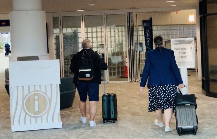 Departing airline passengers head toward the TSA security checkpoint at Daytona Beach International Airport on Wednesday, Nov. 10, 2021.