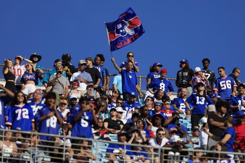 New York Giants fans wave a flag in the upper deck during the fourth quarter of a regular season NFL football matchup Sunday, Oct. 23, 2022 at TIAA Bank Field in Jacksonville. The New York Giants defeated the Jacksonville Jaguars 23-17. [Corey Perrine/Florida Times-Union]