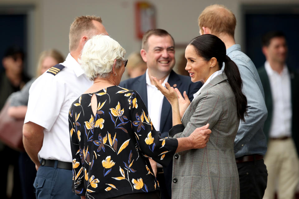 The royal couple meet with health workers as they visit the Royal Flying Doctors Service hangar. Photo: Getty, meghan markle prince harry dubbo, meghan markle prince harry australia, meghan markle serena williams jacket, meghan markle pregnant