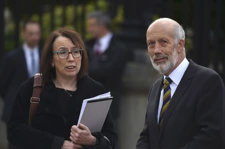 Solicitor Fiona Cassidy and David Forde of the Alliance party depart the High Court in Belfast, Northern Ireland October 28, 2016. REUTERS/Clodagh Kilcoyne