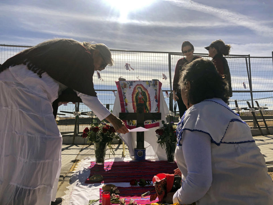 CORRECTS FIRST NAME TO LORRAINE, NOT LORRAIN Sylvia Ledesma, left, and Lorraine Cordova prepare for a service to remember the victims and call for more protection for marginalized and vulnerable women in Albuquerque, N.M., on Saturday, Feb. 2, 2019. Ten years ago, police began unearthing the remains of 11 women and an unborn child found buried on Albuquerque's West Mesa, marking the start of a massive homicide investigation that remains open. Known as the West Mesa killings, the victims' deaths have resulted in no arrests, despite the massive homicide investigation police launched after discovering the makeshift graves. (AP Photo/Mary Hudetz)