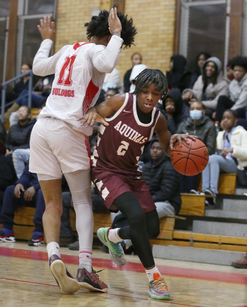 Aquinas's Christian McCullough looks for room along the baseline as Franklin's Kollin McCullough defends.