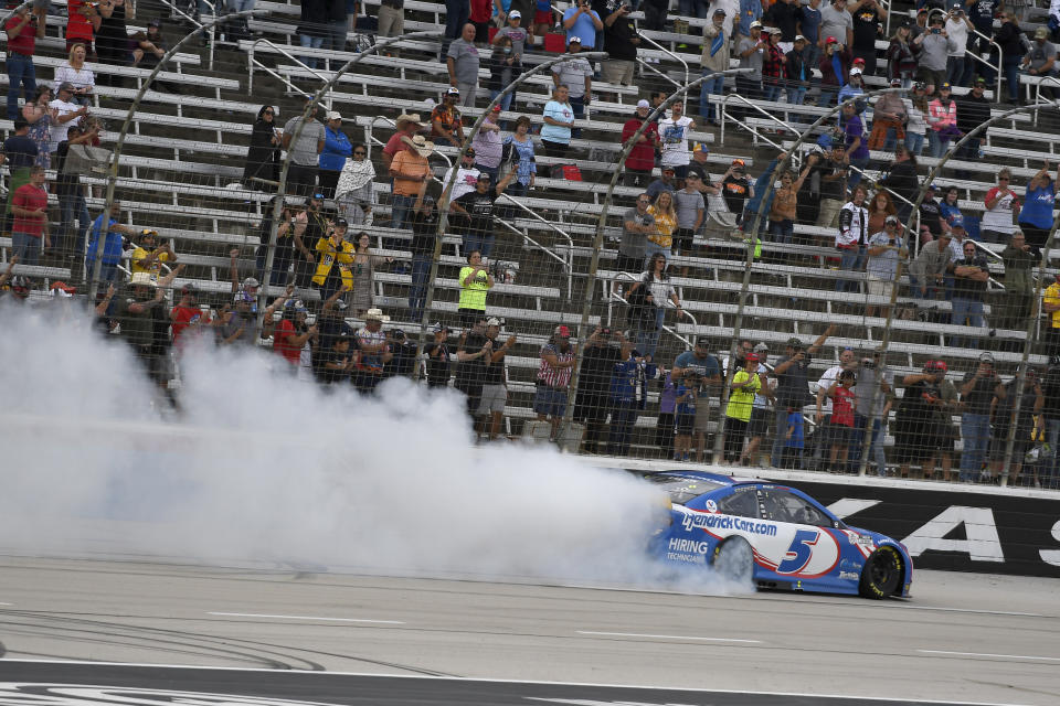 Kyle Larson (5) celebrates after winning a NASCAR Cup Series auto race at Texas Motor Speedway Sunday, Oct. 17, 2021, in Fort Worth, Texas. (AP Photo/Randy Holt)