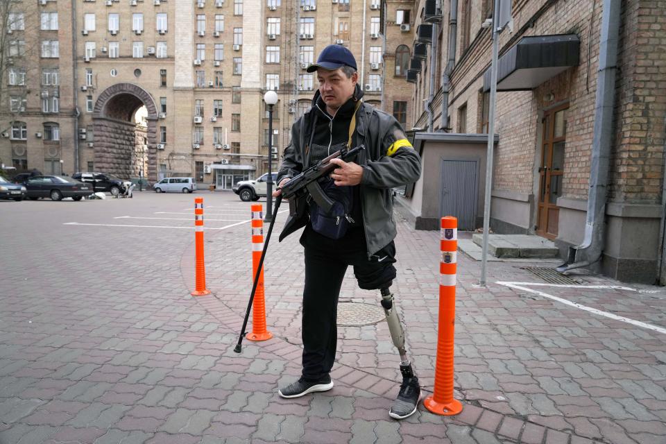 An armed man on an empty street in Kyiv, Ukraine.