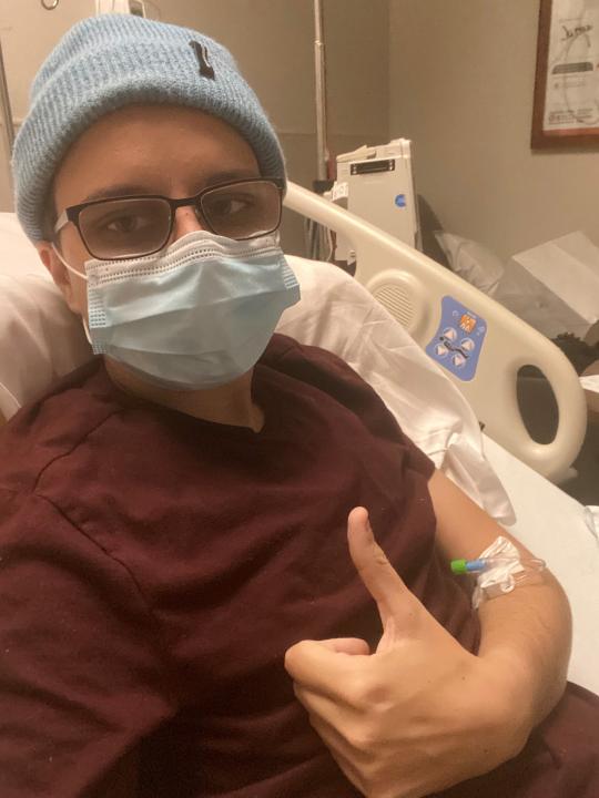 Riley Behrens, 23, sits in his hospital bed at Chandler Regional Medical Center after a TIA, or a mild stroke, on Nov. 29, 2020.