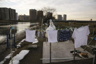 In this Thursday, Jan. 16, 2020, photo, laundry hangs on a line at a homeless camp on the bank of the Tama River, in Tokyo. Like the U.S., Japan has a relatively high poverty rate for a wealthy nation. It also is less generous with social welfare than countries in Europe, and lacks the sorts of private charities prevalent in the U.S. (AP Photo/Jae C. Hong)