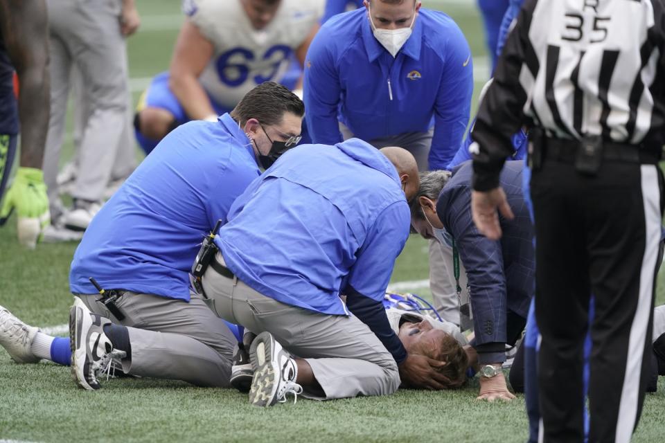 John Wolford is tended to by Rams medical personnel after being injured in the first half against Seattle.