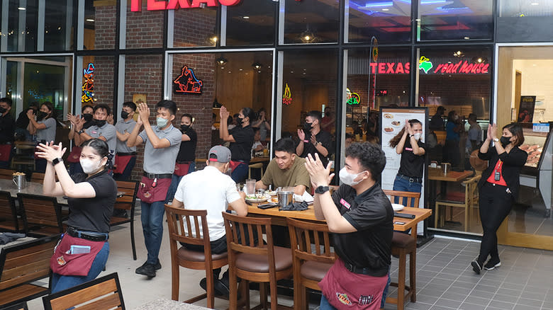 Servers line dancing on the patio