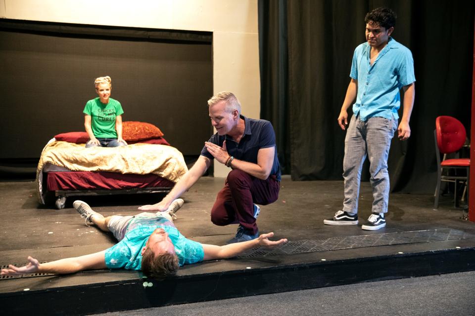 Cast members Christine Tringali Nunes, back, James Owens, on the ground, director Mark Christopher, center, and Carlos Garcia rehearse for, 'Mid-Century Moderns,' at the Desert Rose Playhouse in Palm Springs, Calif., on April 5, 2022. 