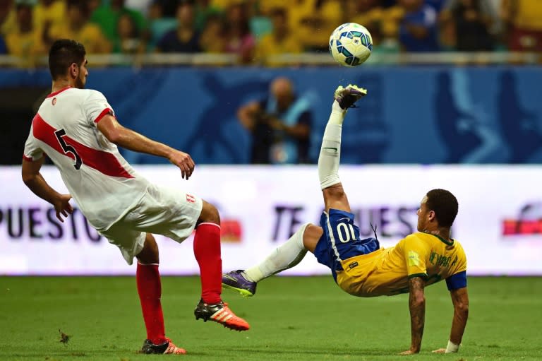 Brazil's Neymar Jr. (R) swings high next to Peru's Carlos Zambrano during their Russia 2018 FIFA World Cup South American Qualifiers match in Salvador de Bahia, on November 17, 2015