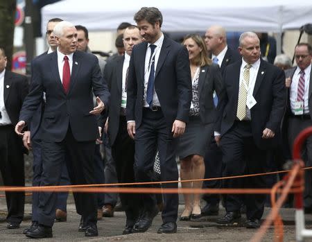 U.S. Vice President Mike Pence walks with members of his delegation ahead of bilateral talks during the 53rd Munich Security Conference in Munich, Germany, February 18, 2017. REUTERS/Michael Dalder