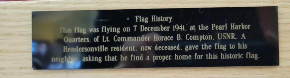 A plaque talks about the history of the Pearl Harbor flag that's on display at the Historic Henderson County Courthouse. The flag flew on Dec. 7, 1941, at Pearl Harbor during the Japanese attack.