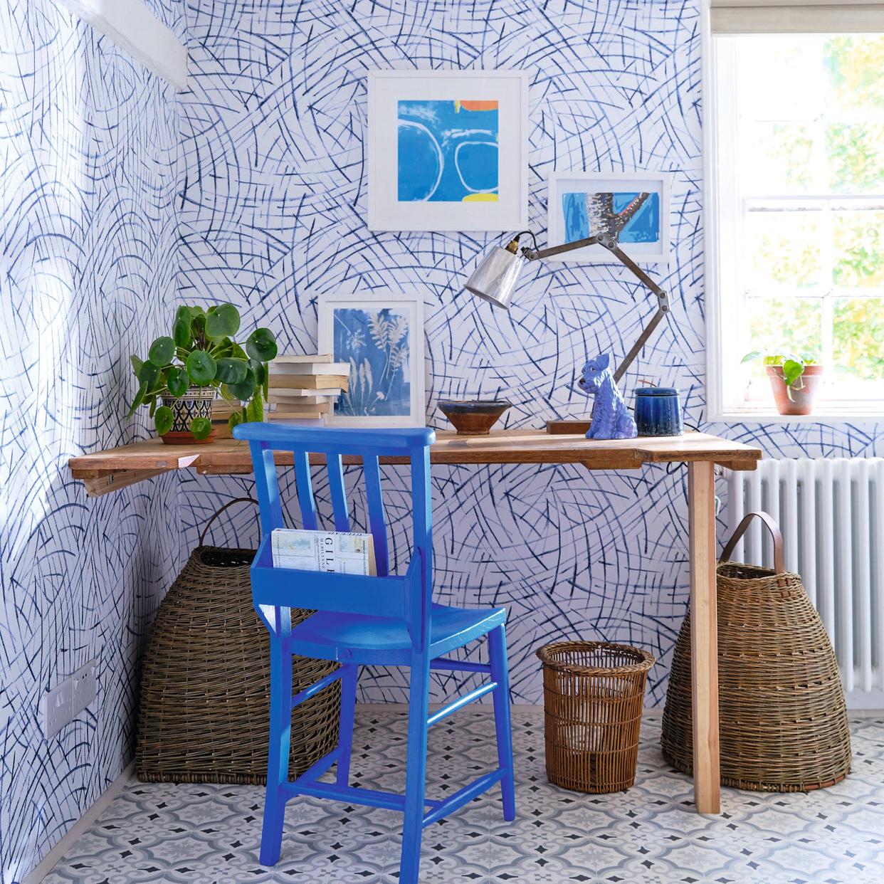  Home office with blue wallpaper and blue patterned flooring. 