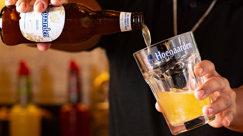 Hoegaarden being poured into a Belgian hex glass