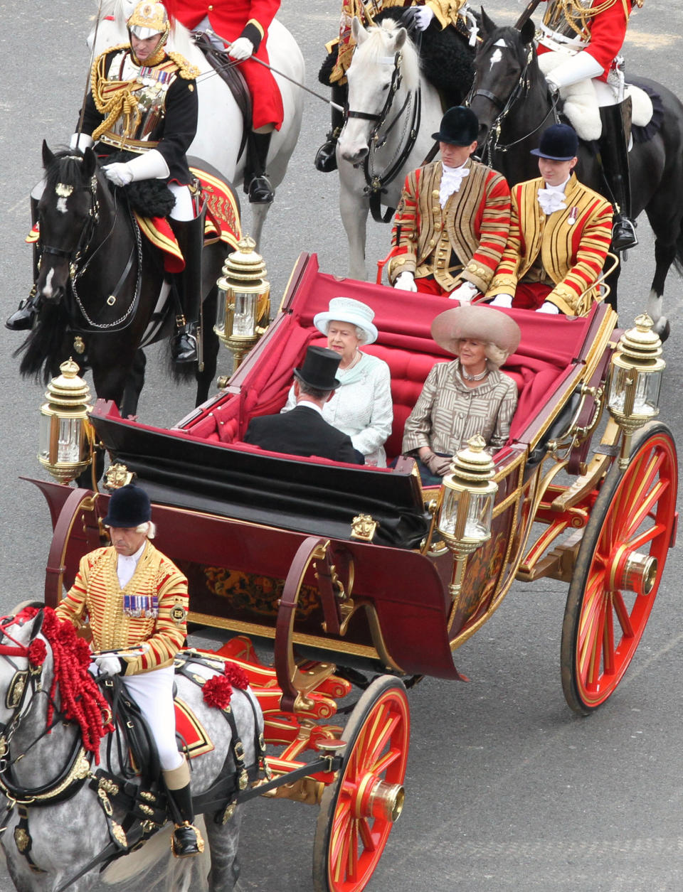 Britain's Queen Elizabeth facing camera left, with Prince Charles and Camilla Duchess of Cornwall, ride in a carriage as they head for Buckingham Palace in a carriage procession in London Tuesday June 5, 2012. The carriage procession is part of a four-day Diamond Jubilee celebration to mark the 60th anniversary of Queen Elizabeth II accession to the throne (AP Photo/Elizabeth Dalziel/Pool)