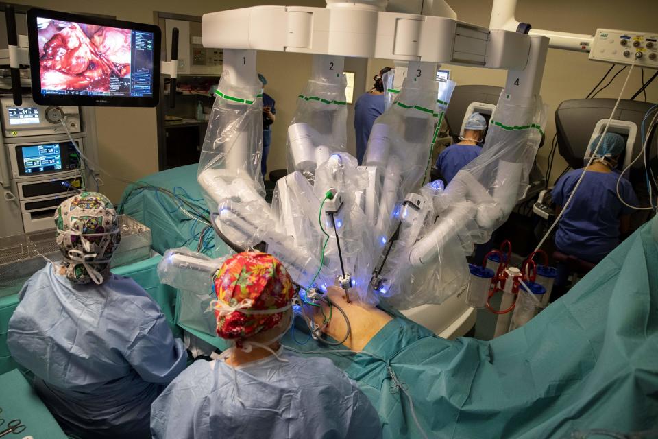 TOPSHOT - A surgeon performs surgery with the da Vinci Xi robotic surgery system at the Robert-Debre Hospital in Paris on April 5, 2019.  - Surgical robots are on the rise despite arguments about added value for cost. Over the past two decades, the US group Intuitive Surgical has installed more than 4,800 Da Vinci series robots worldwide, including his 144 in France. The company's robots have already involved him in more than six million surgical procedures worldwide, including his one million last year, underscoring the sharp acceleration in demand.  (Photo credit: Thomas SAMSON/AFP) (Photo credit to him THOMAS SAMSON/AFP via Getty Images)
