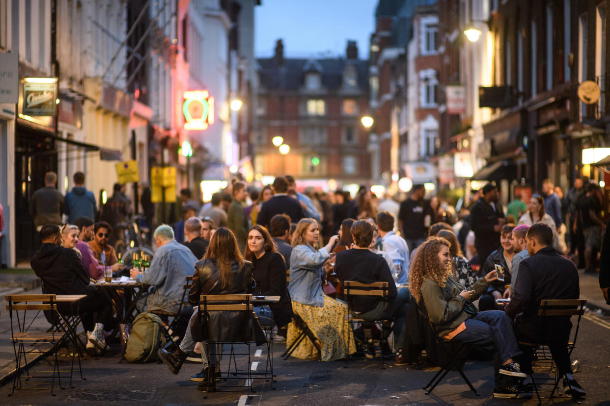 People eat and drink oudoors in Soho, London, as coronavirus lockdown restrictions are eased across England. Many streets in Soho were pedestrianised for the night, and bars and restaurants added extra outdoor seating. Picture date: Sunday July 5, 2020. Photo credit should read: Matt Crossick/Empics