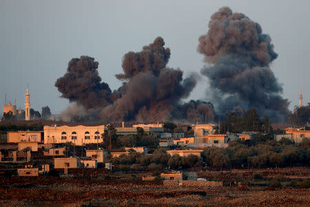 FILE PHOTO: Smoke can be seen following an explosion at the Syrian side of the Israeli-Syrian border as it is seen from the Israeli-occupied Golan Heights, Israel July 23, 2018. REUTERS/Ronen Zvulun