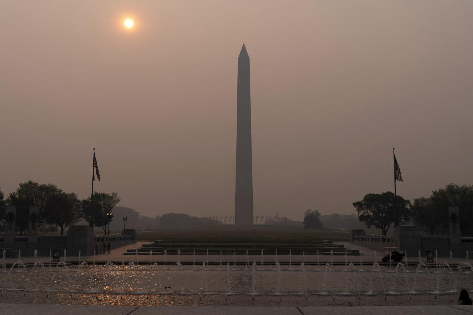 <p>The sun rises above the Washington Monument and a thick layer of smoke, Thursday, June 8, 2023, in Washington. Intense Canadian wildfires are blanketing the northeastern U.S. in a dystopian haze, turning the air acrid, the sky yellowish gray and prompting warnings for vulnerable populations to stay inside. (AP Photo/Jose Luis Magana)</p> 