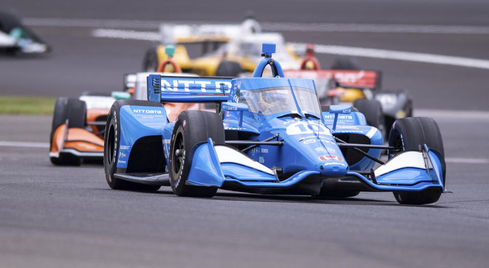 Alex Palou, of Spain, navigates through a turn on the course during a practice session for the IndyCar auto race at Indianapolis Motor Speedway, Friday, Aug. 13, 2021, in Indianapolis. (AP Photo/Doug McSchooler)