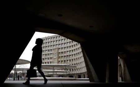 A pedestrian passes the Department of Housing and Urban Developement at the start of the third day of a shut down of the federal government in Washington, U.S., January 22, 2018. REUTERS/Joshua Roberts