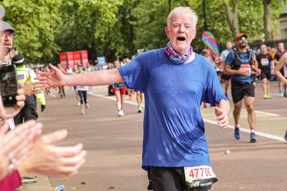 TV and radio presenter Chris Evans. Mass race runners, many in costume, on the last mile at Birdcage Walk. Following a 2-year absence, the Virgin Money London Marathon is back to its traditional course from Blackheath to the Mall. It is set to be the largest marathon staged anywhere, with over 40,000 participants, and a similar number completing the virtual marathon on a course of their choice simultaneously. Credit: Imageplotter/Alamy Live News