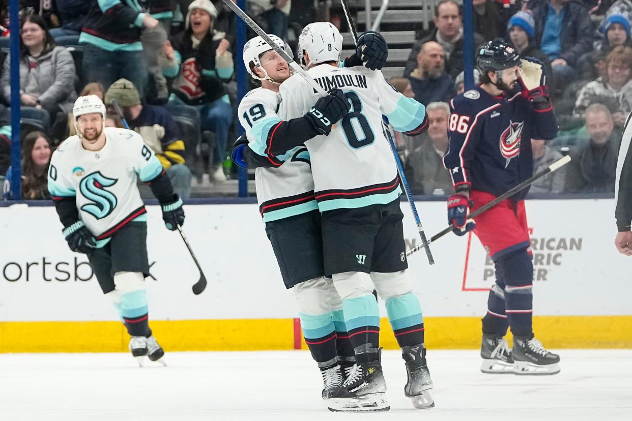 Jan 13, 2024; Columbus, Ohio, USA; Seattle Kraken left wing Jared McCann (19) celebrates a goal by defenseman Brian Dumoulin (8) during the third period of the NHL hockey game against the Columbus Blue Jackets at Nationwide Arena. The Blue Jackets lost 7-4.