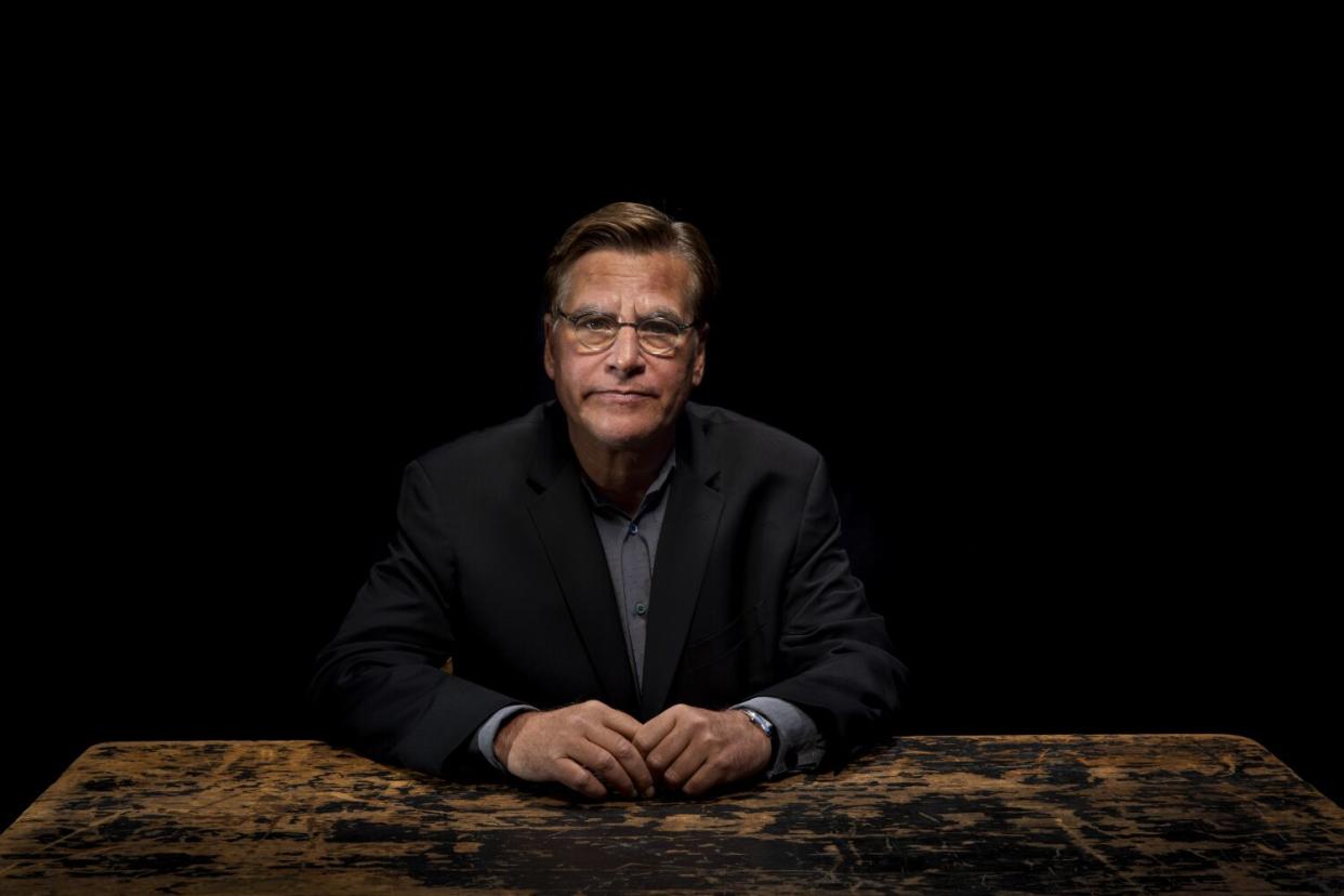 A man in glasses sitting at a table