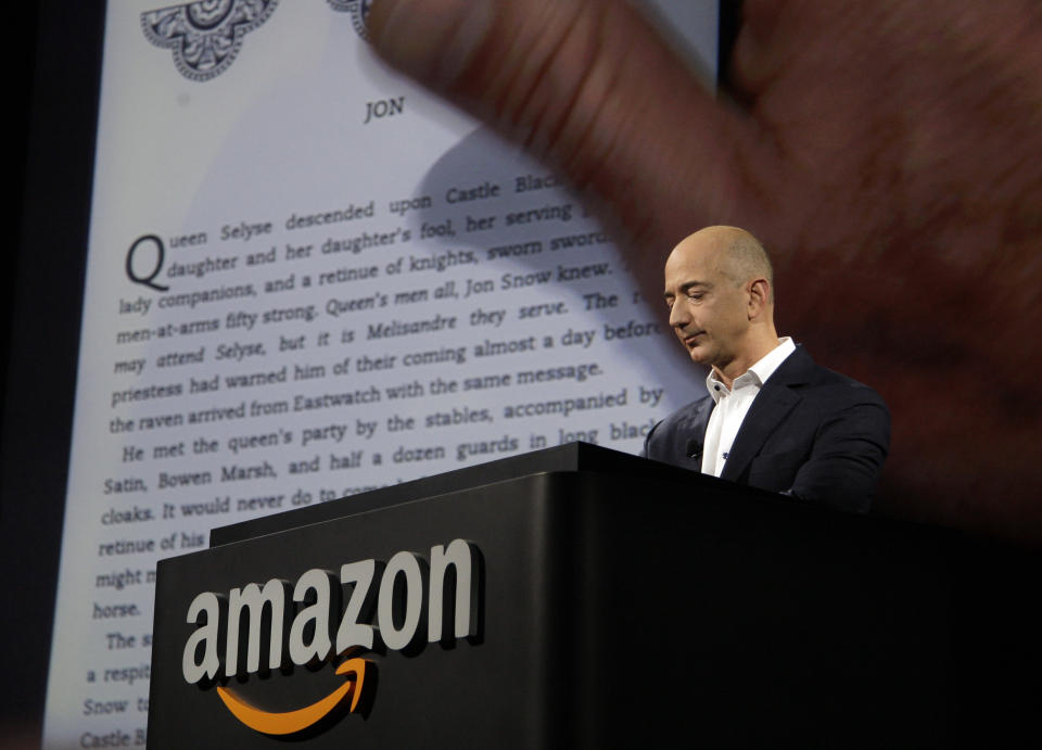 Jeff Bezos, CEO and founder of Amazon, demonstrates a Kindle paperwhite tablet at the introduction of the new Amazon Kindle Fire HD and Kindle Paperwhite in Santa Monica, Calif., Thursday, Sept. 6, 2012. (AP Photo/Reed Saxon)