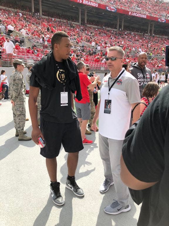 Zed Key, a member of the 2020 recruiting class, speaks with Ohio State basketball coach Chris Holtmann before a Buckeyes football game in September during his official visit. [Adam Jardy/Dispatch]