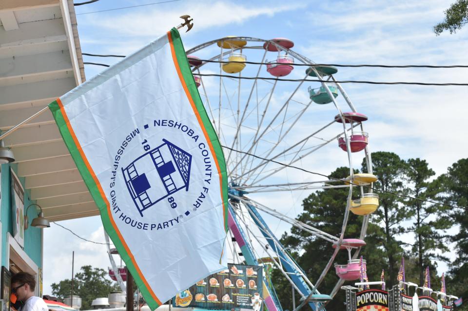 The Neshoba County Fair flag waves in front of the famous fair grounds during the 129th fair. Thursday, Aug. 2, 2018.