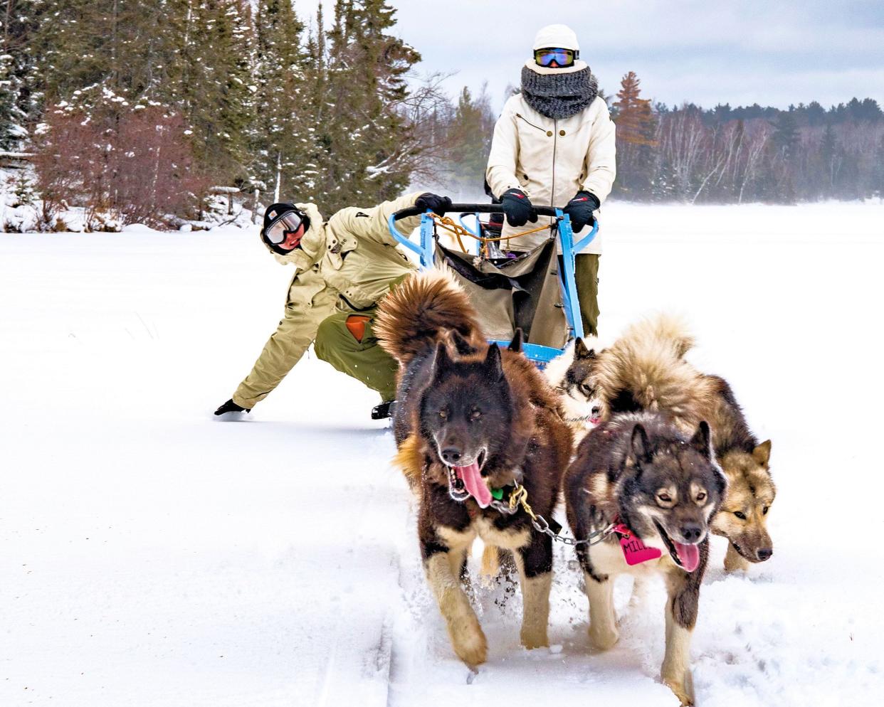 Two mushers enjoy a dogsledding trip through Wintergreen Dogsled Lodge near Ely, Minnesota. Paul and Susan Schurke launched the business in the 1980s. Paul is passing down the business to his son Peter, but worries what climate change will mean for its future.