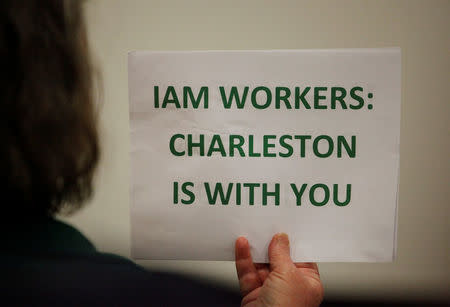 A supporter holds a small sign at a rally held by The International Association of Machinists and Aerospace Workers for Boeing South Carolina workers before Wednesday's vote to organize, in North Charleston, South Carolina, U.S. February 13, 2017. REUTERS/Randall Hill