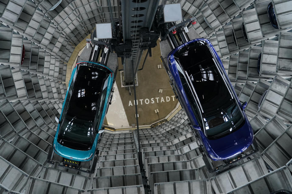 WOLFSBURG, GERMANY - OCTOBER 26: Volkswagen ID.4 (R) and ID.3 electric cars stand on elevator platforms inside one of the twin towers used as storage at the Autostadt promotional facility next to the Volkswagen factory on October 26, 2020 in Wolfsburg, Germany. The ID.3 and ID.4 are Volkswagen's first real effort to break into the growing electric car market and are aimed for mass appeal.   (Photo by Sean Gallup/Getty Images)