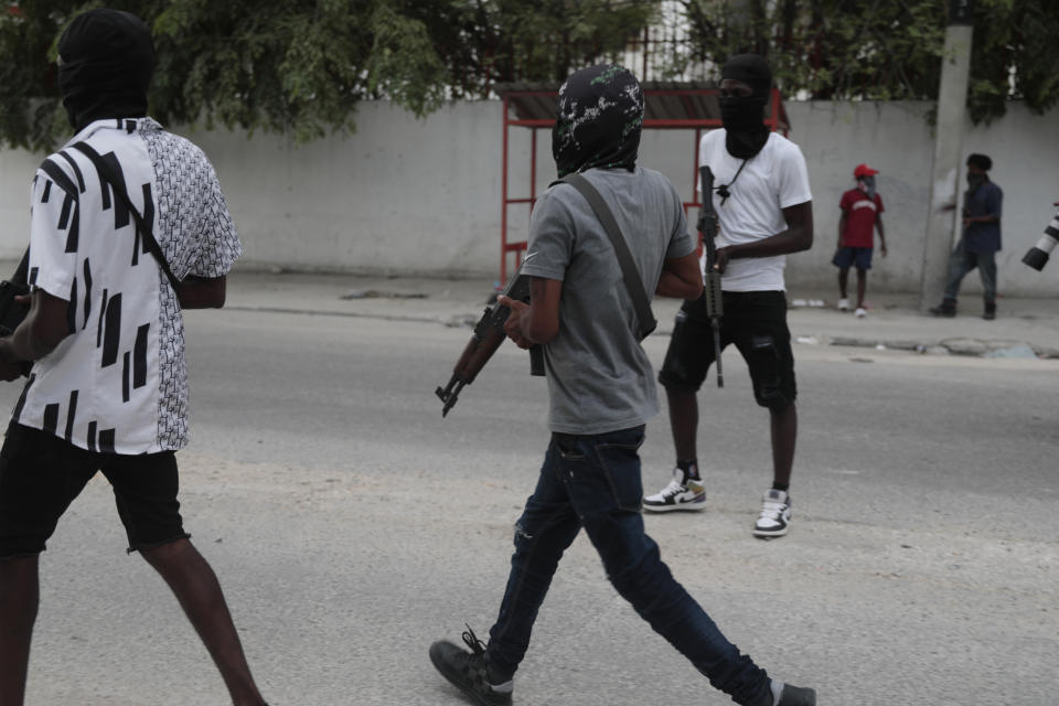 Armed members of "G9 and Family" secure a street during a protest against Haitian Prime Minister Ariel Henry in Port-au-Prince, Haiti, Tuesday, Sept. 19, 2023. (AP Photo/Odelyn Joseph)
