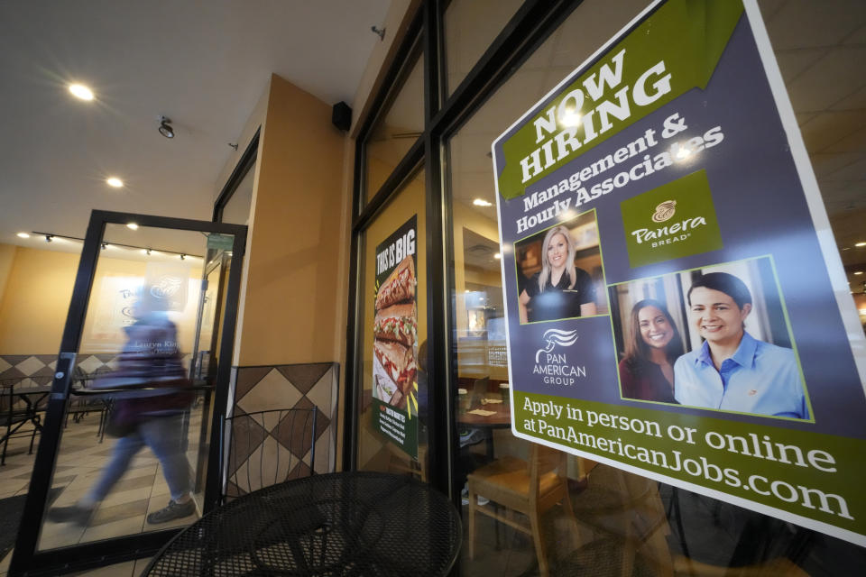 File - A hiring sign is displayed in the window of a Panera Bread store in Pittsburgh on Monday, Jan. 23, 2023. A strong job market has helped fuel the inflation pressures that have led the Federal Reserve to keep raising interest rates. (AP Photo/Gene J. Puskar, File)
