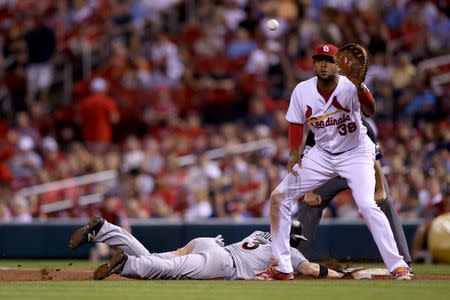 Jun 5, 2018; St. Louis, MO, USA; Miami Marlins center fielder J.B. Shuck (3) dives back to first base to avoid a pickoff throw to St. Louis Cardinals first baseman Jose Martinez (38) during the eighth inning at Busch Stadium. Mandatory Credit: Scott Kane-USA TODAY Sports