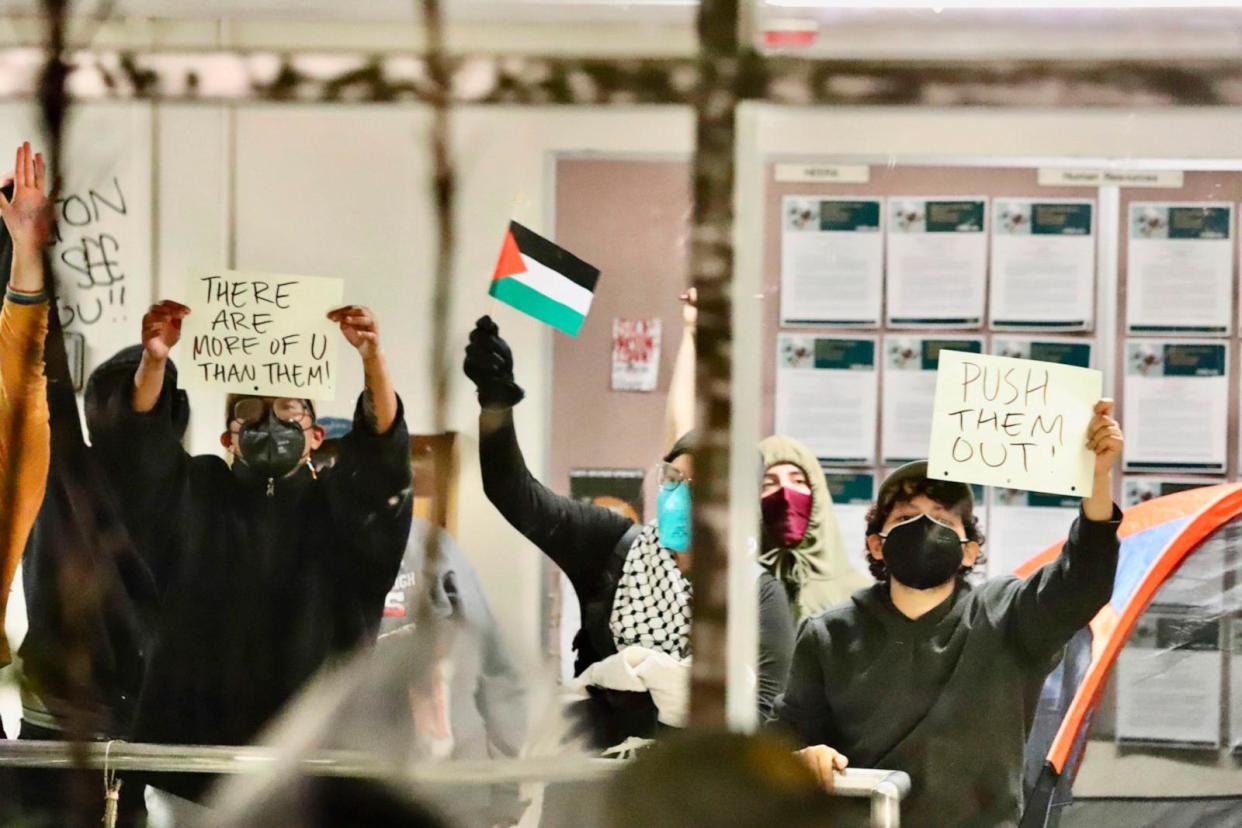 PHOTO: Pro-Palestinian protesters hold up signs while occupying a building on the campus of California State Polytechnic University, Humboldt, in Arcata, Calif., Monday, April 22, 2024. (Andrew Goff/Lost Coast Outpost via AP)