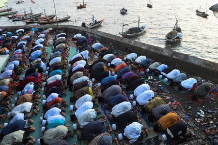 Muslims perform prayers for Eid Al-Fitr at Al-Mabrur mosque in Surabaya, East Java, Indonesia June 25, 2017 in this photo taken by Antara Foto. Antara Foto/Zabur Karuru/ via REUTERS