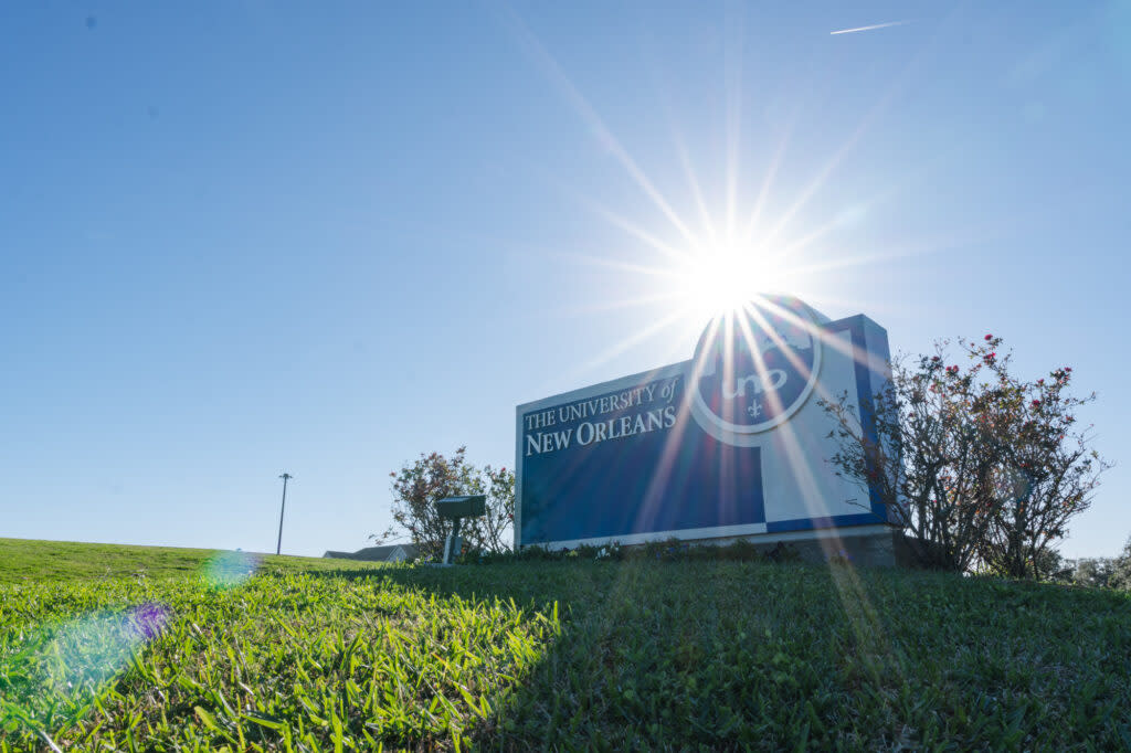 The sun shines brightly on Thursday, Dec. 15, 2022, above the University of New Orleans entrance sign on Lakeshore Drive.