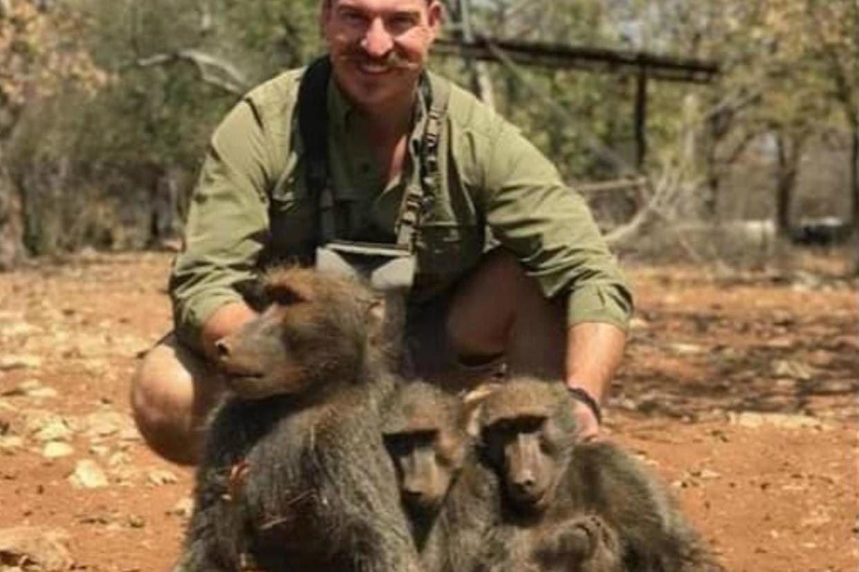 Blake Fischer, an Idaho Fish and Game Commissioner, has been called on to resign after posing for a picture with the family of baboons he killed: Idaho Governor's Office