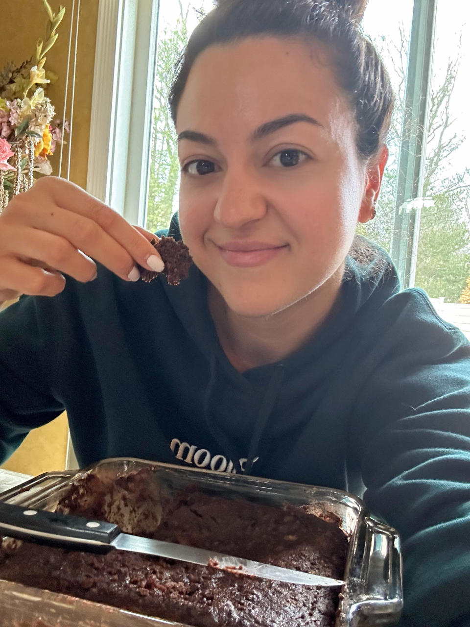 the author posing for a selfie with the cake