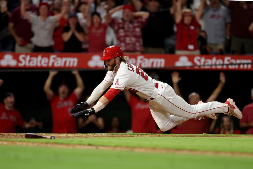 Angels' Trey Cabbage scores the winning run in the 10th inning against the Houston Astros on July 15, 2023, in Anaheim.