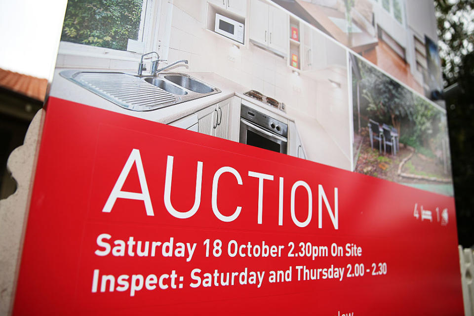 An auction sign stands on display outside a house in the suburb of Waverton in Sydney, Australia, on Saturday, Oct. 18, 2014.