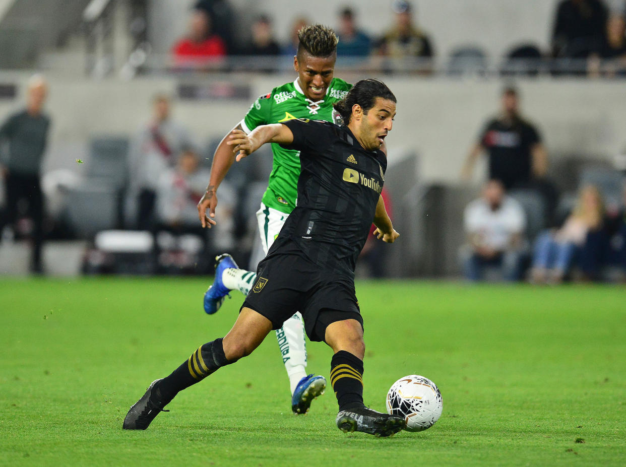 February 27, 2020; Los Angeles, California, USA; Los Angeles FC forward Carlos Vela (10) moves the ball against Leon midfielder Pedro Aquino (18) during the second half at Banc of California Stadium. Mandatory Credit: Gary A. Vasquez-USA TODAY Sports