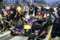 Red Bull Formula One driver Sebastian Vettel of Germany makes a pit stop during the third practice session of the Singapore F1 Grand Prix at the Marina Bay street circuit in Singapore September 21, 2013. REUTERS/Pablo Sanchez (SINGAPORE - Tags: SPORT MOTORSPORT F1)