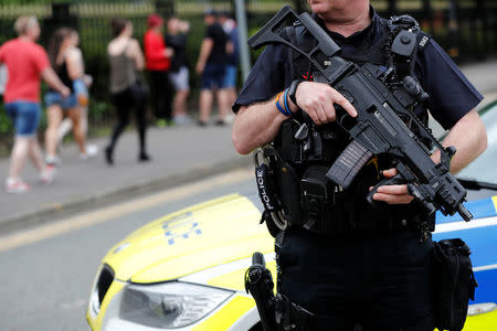 An armed policeman is seen outside the Lancashire County Cricket Club, Emirates Old Trafford, in Manchester, Britain May 27, 2017. REUTERS/Stefan Wermuth