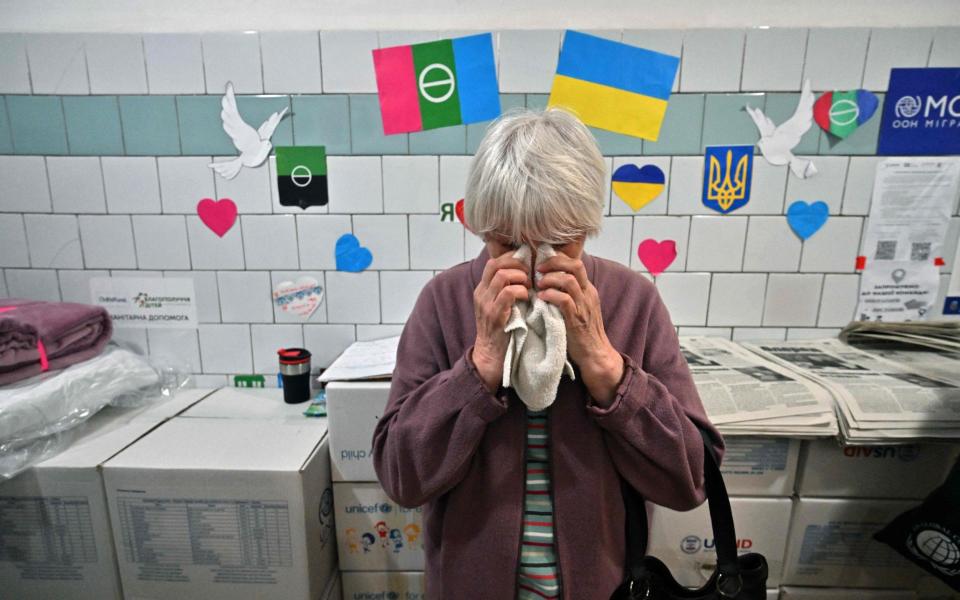 An elderly displaced Bakhmut resident cries as she visits a support centre in Kyiv - SERGEI SUPINSKY/AFP